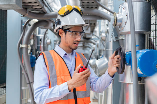 istock Engineer inspects water heater pump system and hot water tank on industrial roof 2158438321
