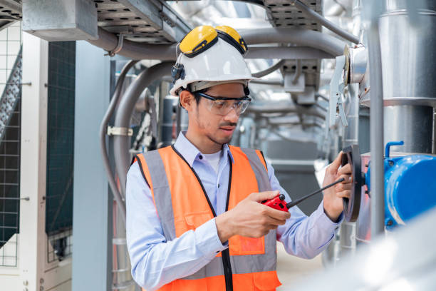 istock Engineer inspects water heater pump system and hot water tank on industrial roof 2158438521