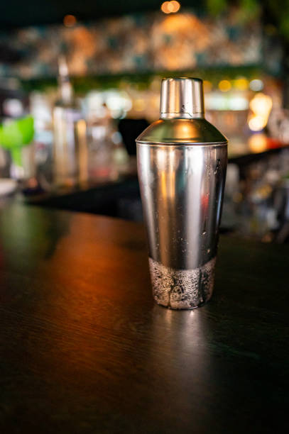 istock Stainless steel cocktail shaker on a dark bar counter 2158438979
