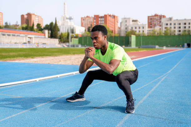 istock A african man is doing a squat on a track 2158442831