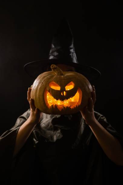 istock Pumpkin jack o lantern instead of a woman's head. Halloween 2158444466