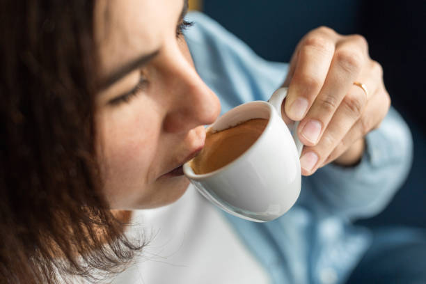 istock Woman drinking coffee from small cup at home 2158446366