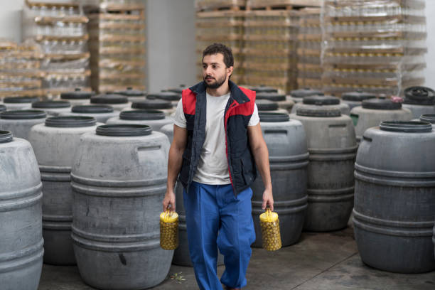 istock Worker in olives factory warehopuse 2158446932