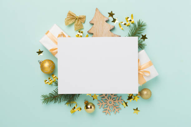 istock Greeting card mockup with christmas decor on color background, top view 2158448286