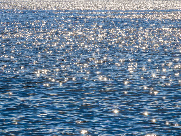 istock The water is calm and the sun is shining on it, creating a beautiful reflection 2158453955