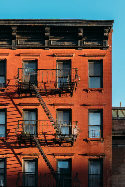 istock Morning Sunlight on Red Brick Building with Iron Fire Escapes in NYC 2158454746
