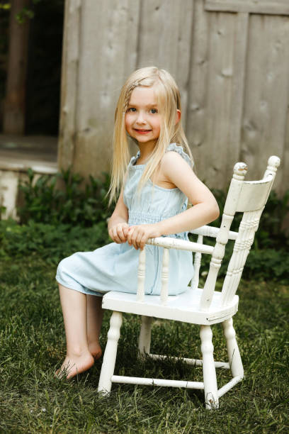 Rear view of little girl sitting on stoolhttp://www.twodozendesign.info/i/1.png