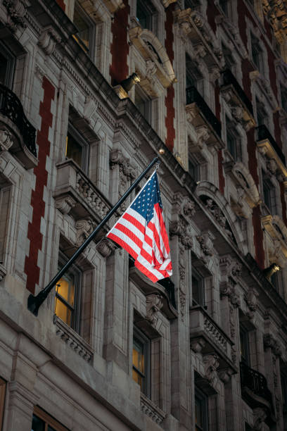 istock Proud American Flag Hanging from Traditional New York Architecture 2158458262