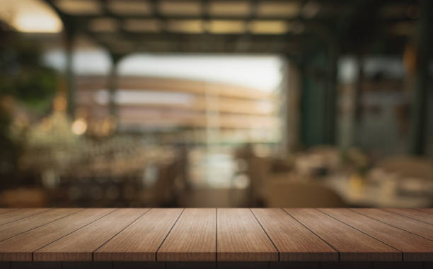 istock Empty wooden table top with lights bokeh on blur restaurant background. 2158460645
