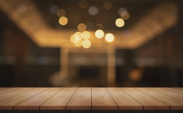 istock Empty wooden table top with lights bokeh on blur restaurant background. 2158460648