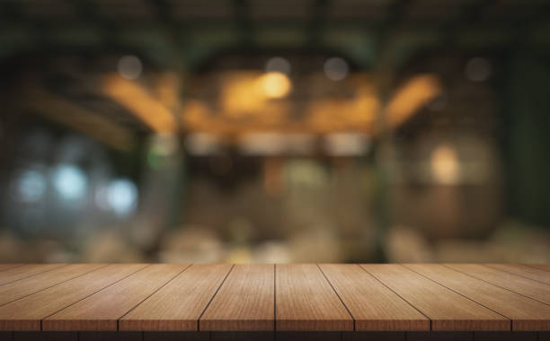 istock Empty wooden table top with lights bokeh on blur restaurant background. 2158460653