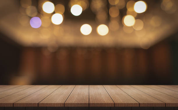 istock Empty wooden table top with lights bokeh on blur restaurant background. 2158460664