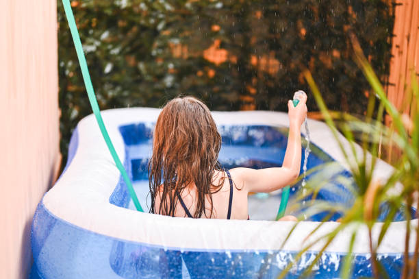 istock Child in inflatable swimming pool. 2158461615