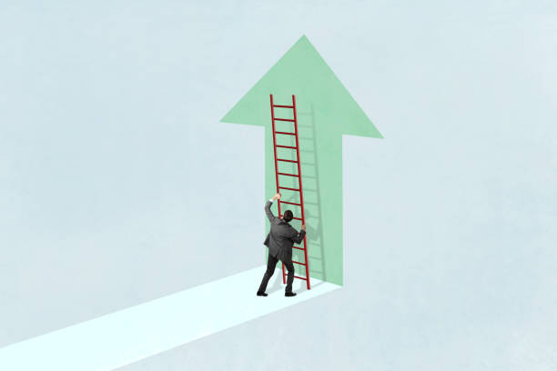 istock Man Positions Ladder To Climb Upward Pointing Arrow 2158462658
