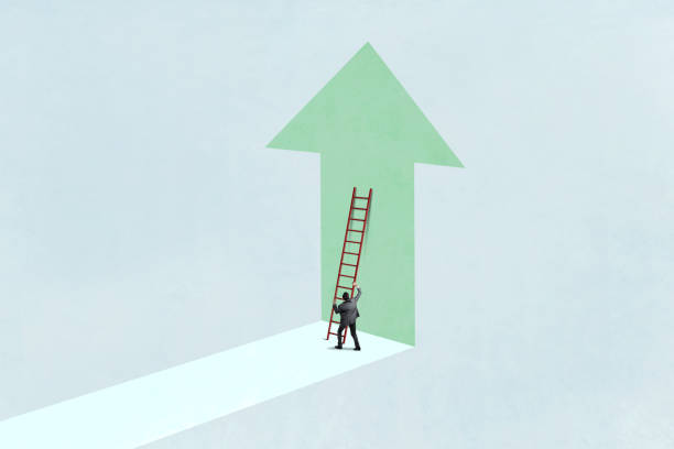 istock Man Positions Ladder To Climb Upward Pointing Arrow 2158462659
