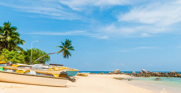 istock Boats on the sand in a beach under a blue sky 2158467549