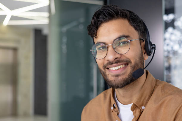 istock Smiling customer service representative wearing a headset in a modern office environment 2158467624