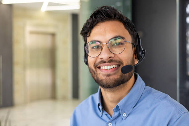 istock Friendly customer service representative with headset ready to assist customers 2158469084