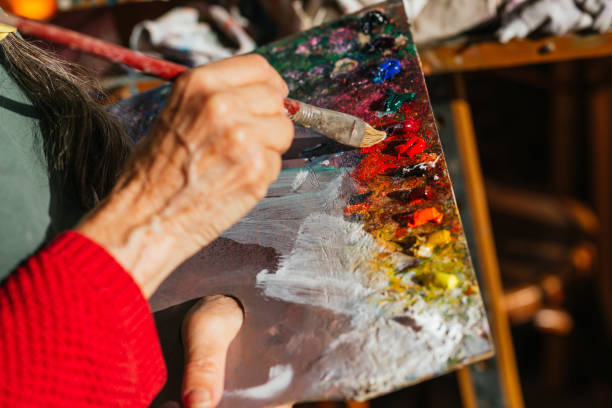 istock Crop aged artist with paint palette in workshop 2158473622