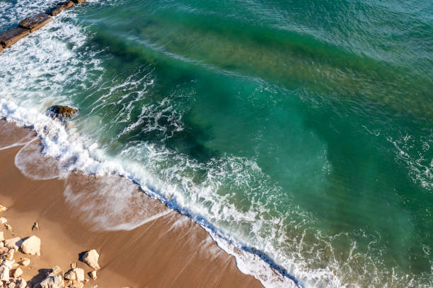 istock beautiful wave splash on a rocky cost 2158478897
