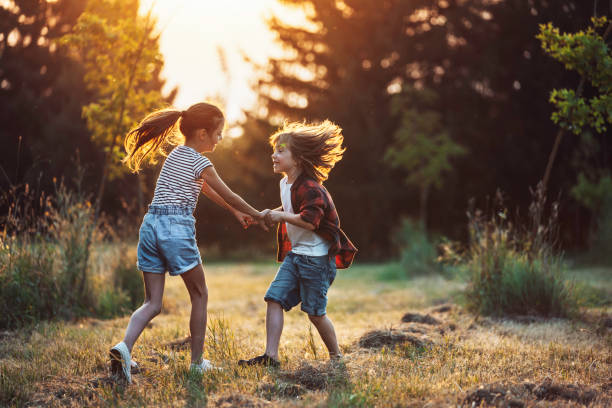 istock Children playing in the park during sunny evening. 2158478958