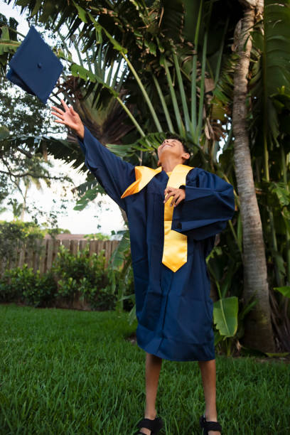 istock Portrait of jumping young boy graduating from elementary school. 2158487001