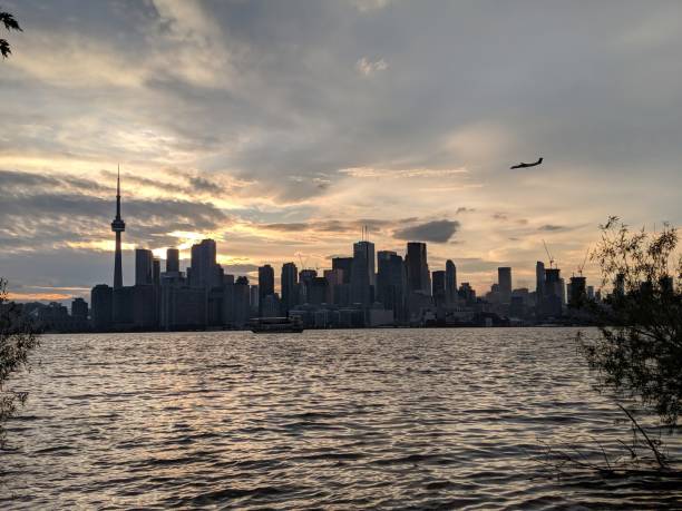 istock The Toronto Skyline at sunset with a plane landing 2158487589