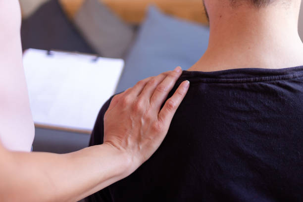 istock Doctor comforting patient placing hand on man's back 2158488570