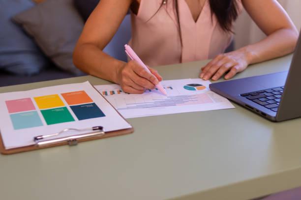 istock Businesswoman analyzing financial charts and data at home office 2158488817