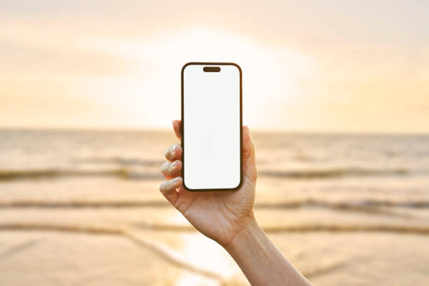 istock Young woman showing mobile phone blank white screen on Marina Background 2158492320