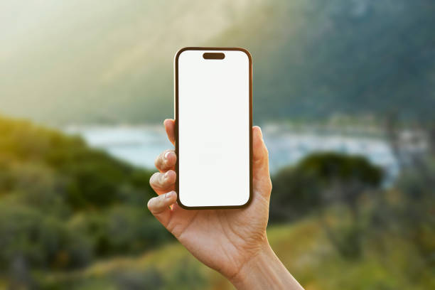 istock Young woman showing mobile phone blank white screen on Marina Background 2158492327