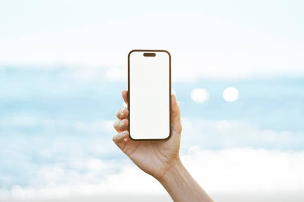 istock Young woman showing mobile phone blank white screen on Marina Background 2158492330