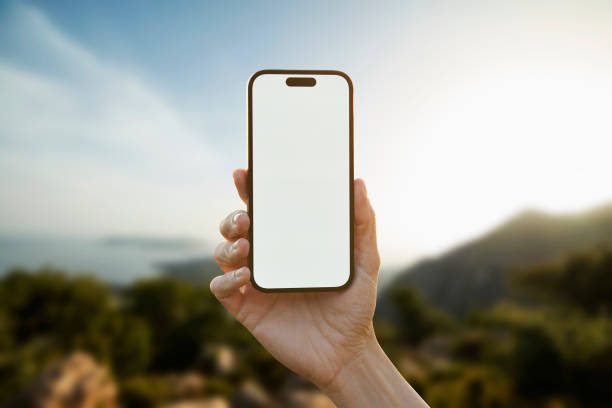 istock Young woman showing mobile phone blank white screen on Marina Background 2158492333