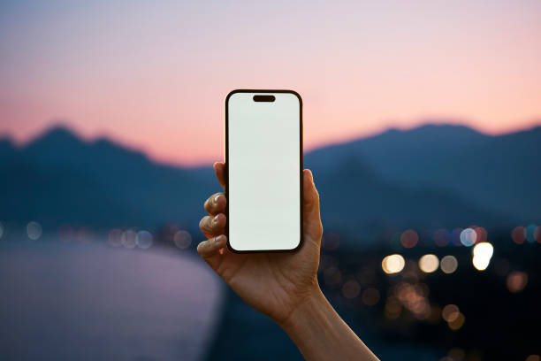 Young woman showing mobile phone blank white screen on Marina Background