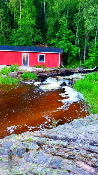 istock house near the mountain river 2158492497