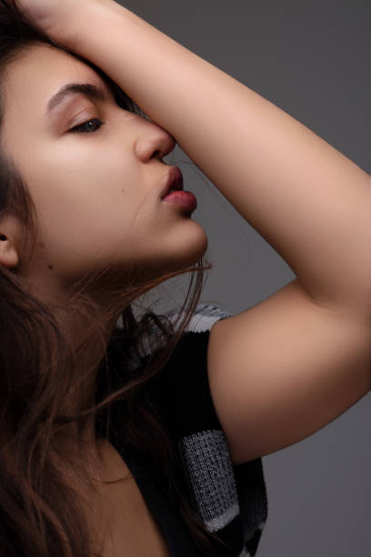 istock Fashion model posing with hand in hair 2158496185