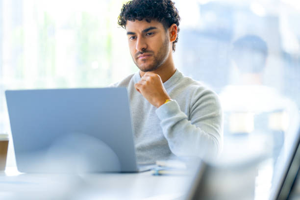 istock Serious thoughtful businessman working on a laptop computer in the office 2158498928