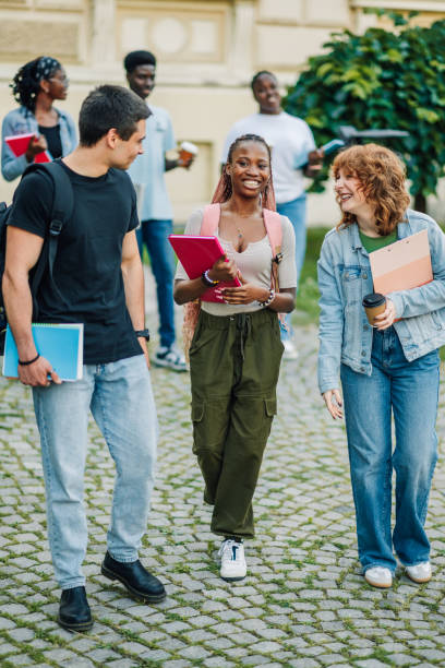 istock Full length shot of diverse students at campus walking towards camera. 2158502425