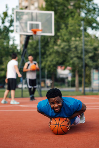 istock Player stretches reaching for basketball 2158502438