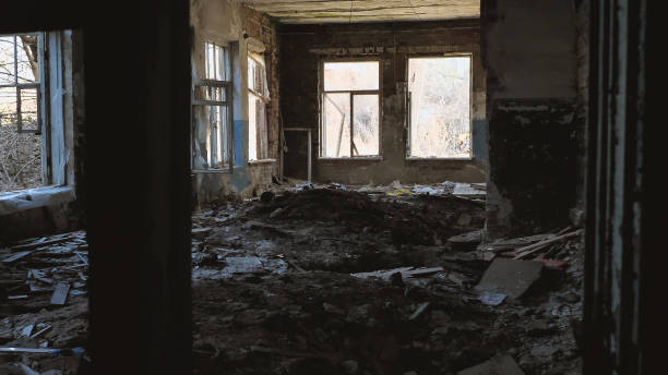 istock An abandoned, dilapidated room with broken windows and rubbish scattered on floor 2158502937