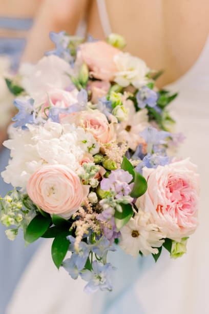 istock Bride is holding wedding bouquet behind her back. 2158503311