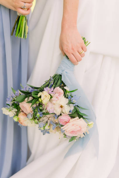 istock Bride is standing next to a bridesmaid and holding a wedding bouquet. 2158503318