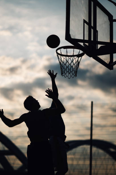 istock Player aiming a basketball into hoop 2158503444