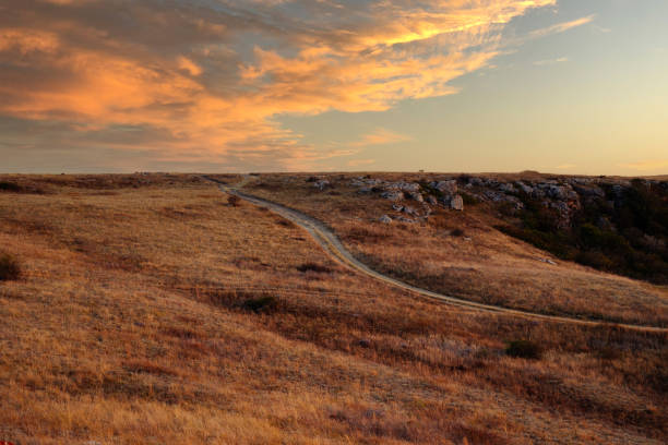 istock Evening sunset landscape. The road through hilly, sun-scorched terrain. Rocky Valley 2158507618