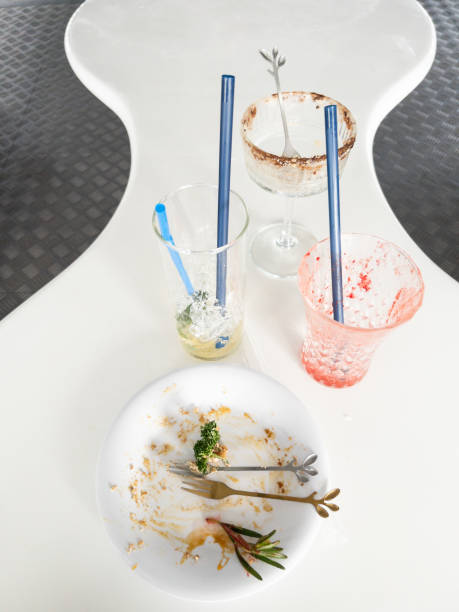 A white plate of cake and a glass of iced coffee after eating