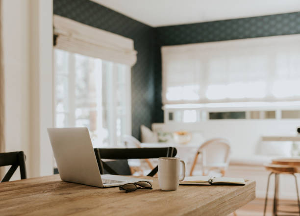 istock Notebook and a cup of coffee on a wooden table 2158510475