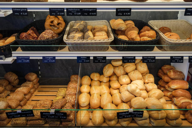 istock Freshly baked bread rolls lie in the display of a bakery 2158510648