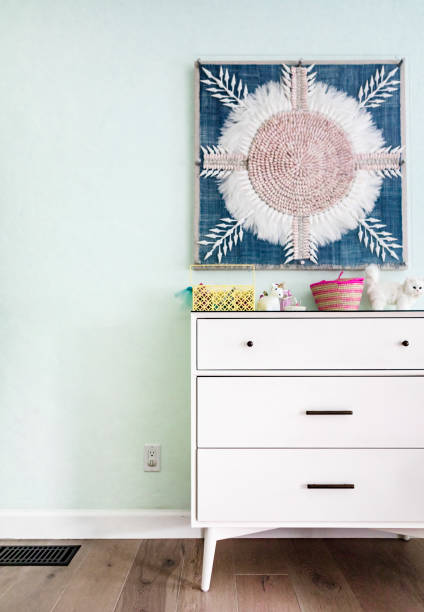 istock Art hanging on a wall above a drawer 2158511784