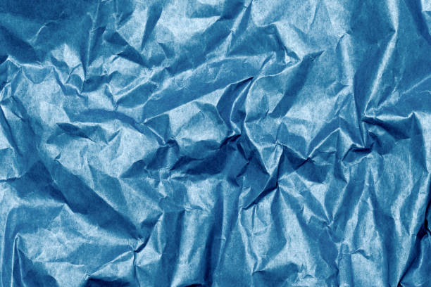 istock Crumpled blue paper textured background 2158511828