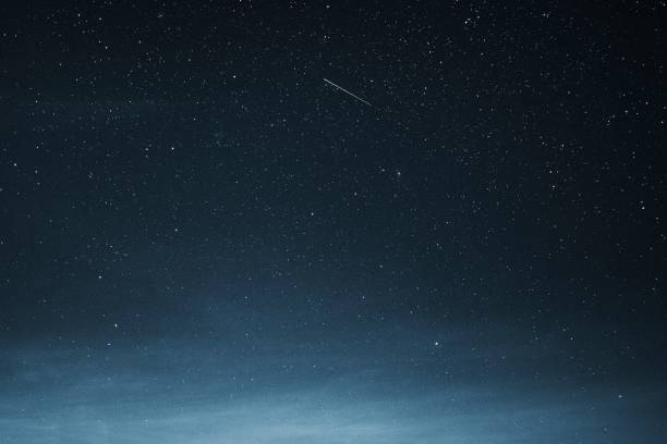 Shooting star in the dark blue sky over Greenland